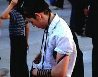 Con i tefillin, le scatole, con 4 testi della Torah, con le cinghie che le legano alla testa ed al braccio